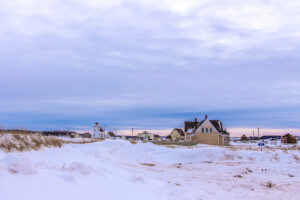A beautiful view of rural houses under a cloudy sky in winter